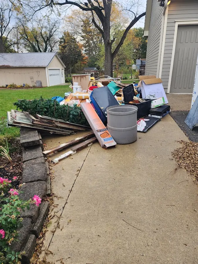 Dumpster being loaded with debris for 12 Yard Dumpster Rental in Roseland